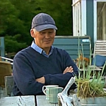 Michael Faulkner sitting by a garden table.