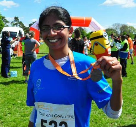 Ayesha Chari with a medal in her hand after a race.