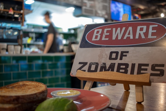 Sign in a cafe, which reads 'beware of zombies'.