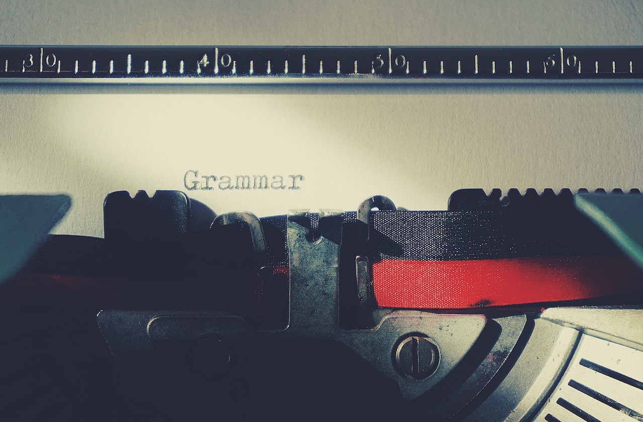A typewriter with the word 'grammar' typewritten on the inserted paper