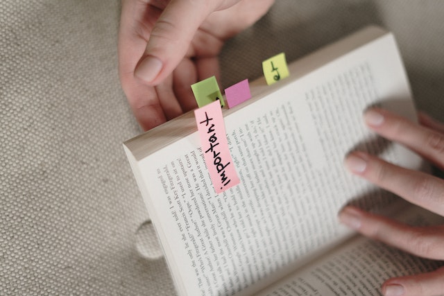 Book marked with sticky notes