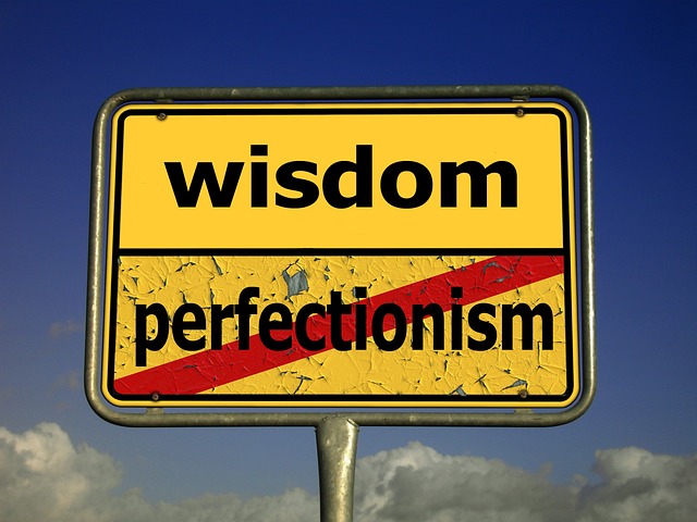 Sign saying wisdom with perfectionism crossed out